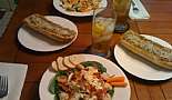 Shrimp and spinach salads with eggs, bacon, carrots, cheese, bagel chips and garlic bread.